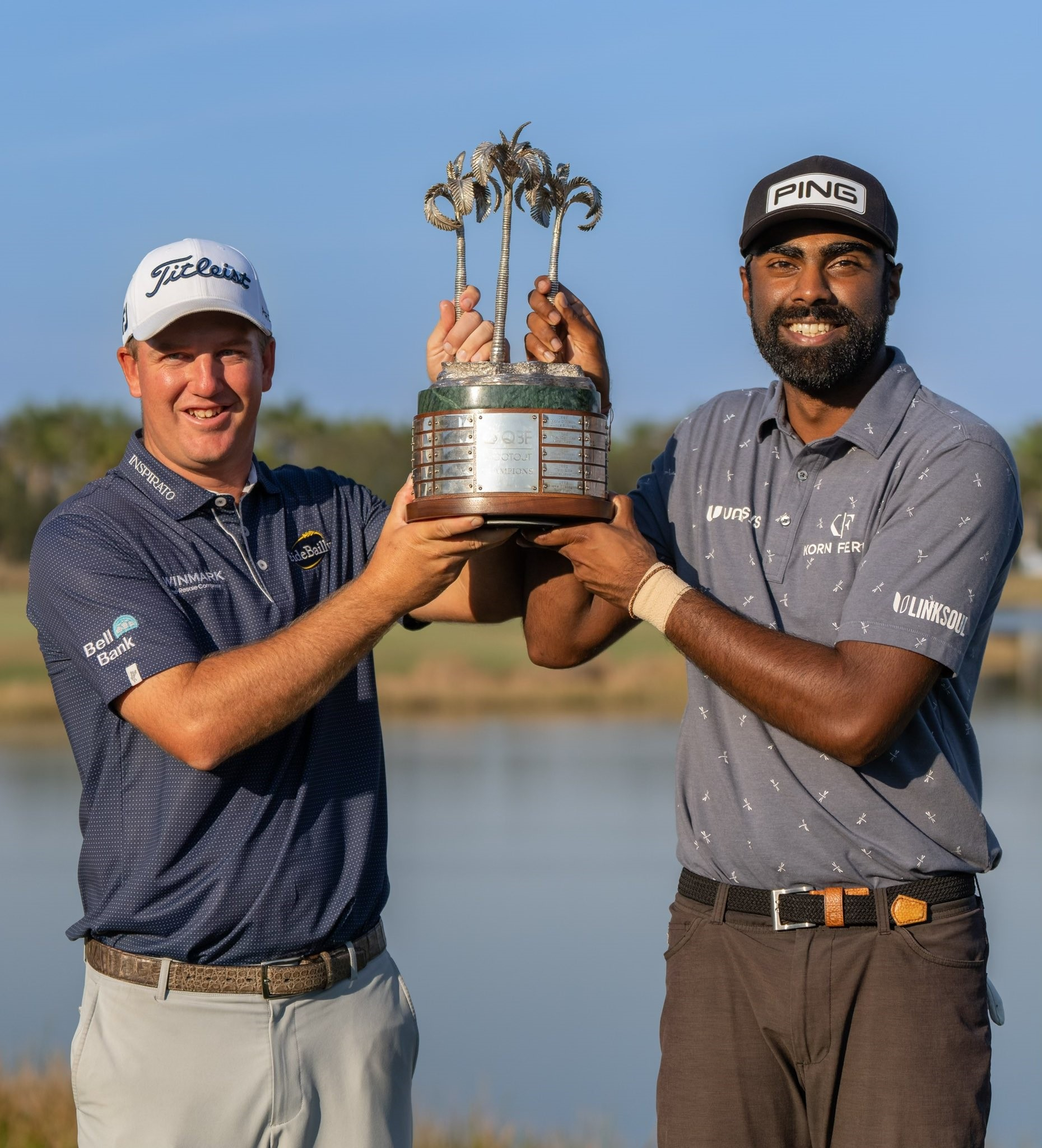 QBE Shootout Champions Sahith Reddy Theegala and Tom Hoge with QBE Shootout trophy made by Malcolm DeMille